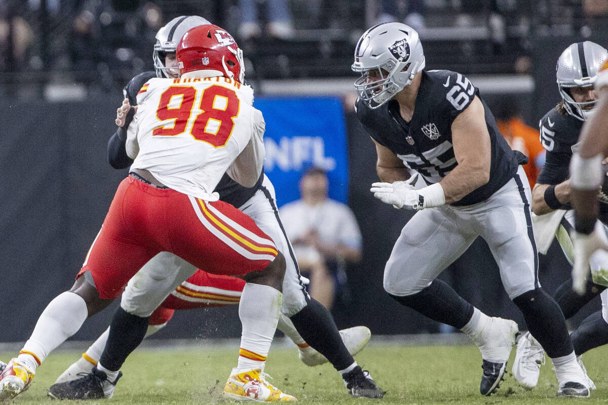 Raiders guard Cody Whitehair (65) moves in to assist offensive lineman Jackson Powers-Johnson ( ...