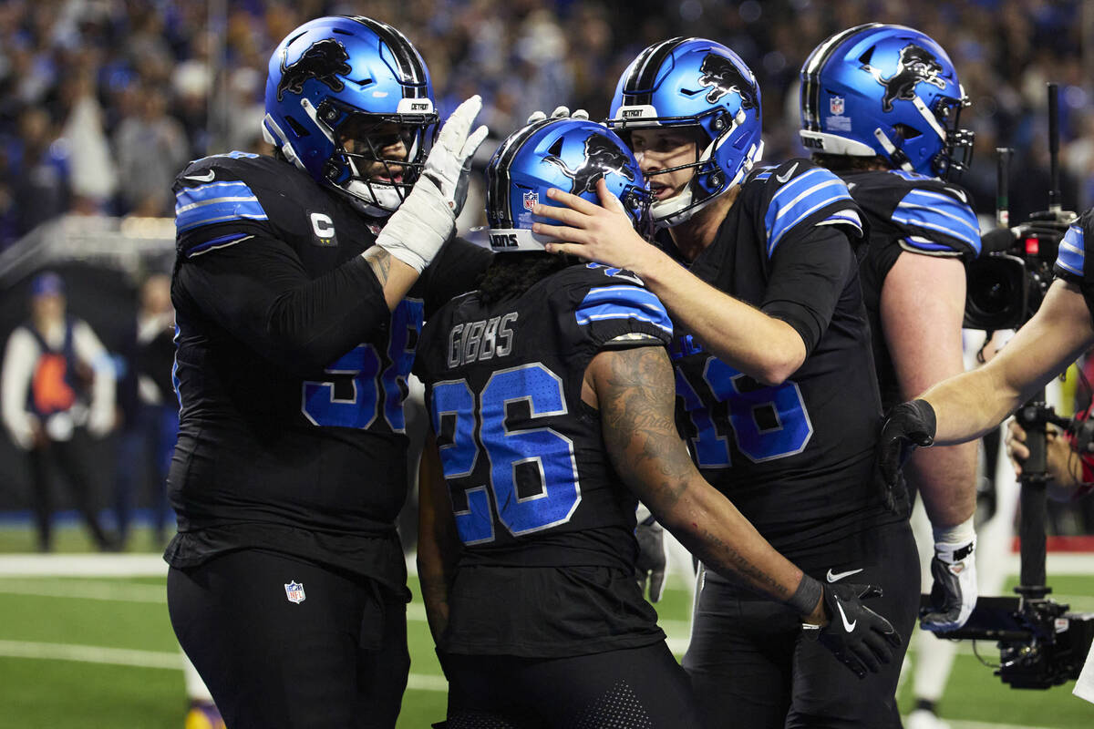 Detroit Lions running back Jahmyr Gibbs (26) receives congratulations from offensive tackle Pen ...