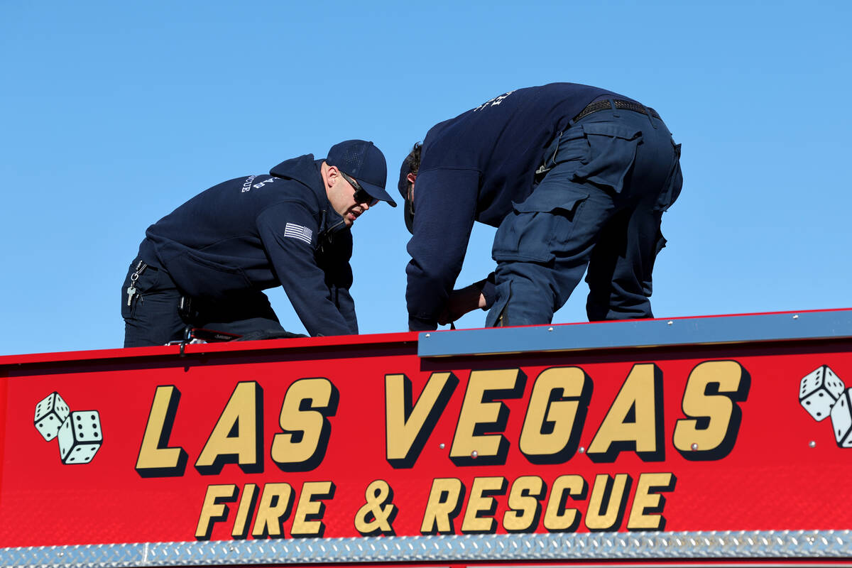 Firefighters from Clark County Fire Department and Las Vegas Fire and Rescue pack at the Clark ...