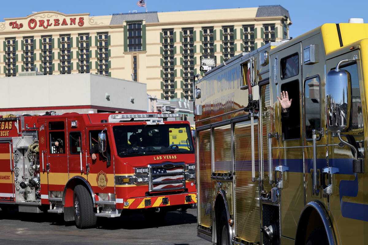 Firefighters from the Clark County Fire Department and Las Vegas Fire and Rescue lave the Clark ...