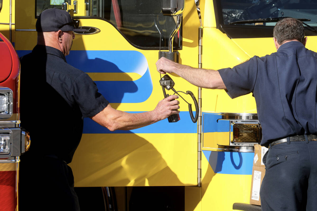 Firefighters from Clark County Fire Department and Las Vegas Fire and Rescue pack at the Clark ...