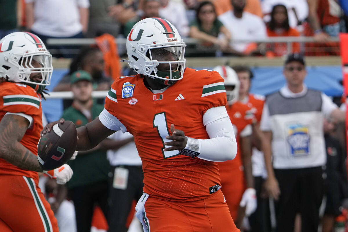 Miami quarterback Cam Ward (1) throws a pass during the first half of the Pop Tarts Bowl NCAA c ...