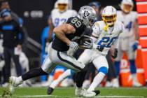 Raiders tight end Brock Bowers (89) looks to run past Los Angeles Chargers cornerback Cam Hart ...