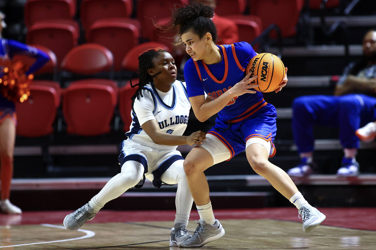 Bishop Gorman's Aaliah Spaight (10) dribbles against Centennial's Tessa Prince (3) during the s ...