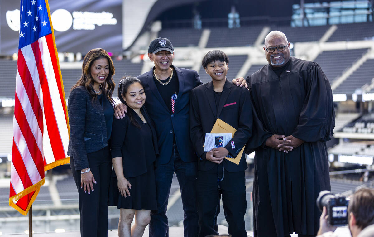 Raiders President Sandra Douglass-Morgan joins family members Diane, Philip and Dwain Valin wit ...