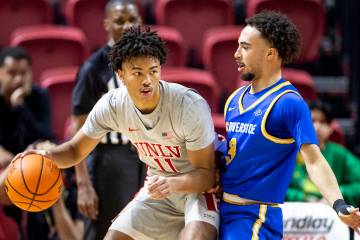 UNLV guard Dedan Thomas Jr. (11) looks to pass UC Riverside Highlanders guard Isaiah Moses (3) ...