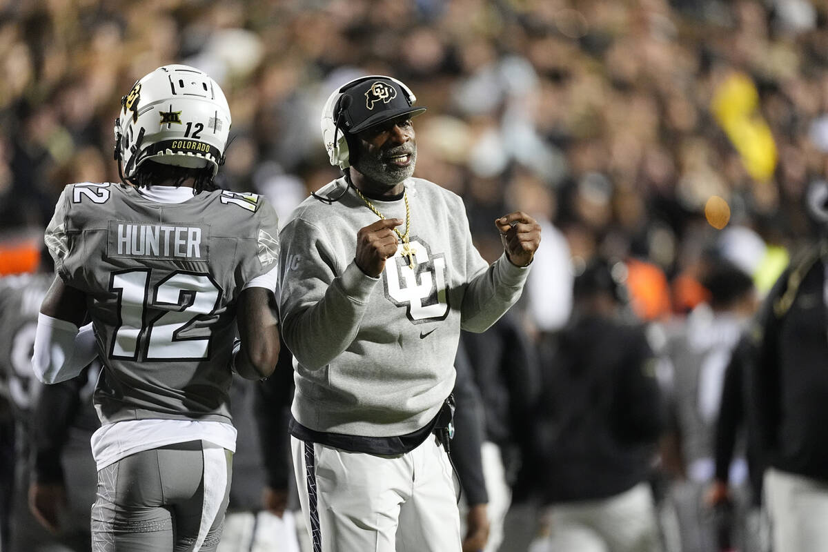 Colorado wide receiver Travis Hunter (12) and Colorado head coach Deion Sanders in the first ha ...