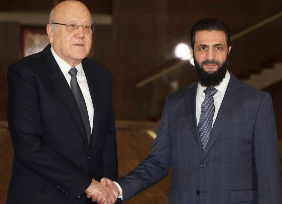 In this photo released by Lebanon's Prime Minister's office, Syria's de facto leader Ahmad al-S ...