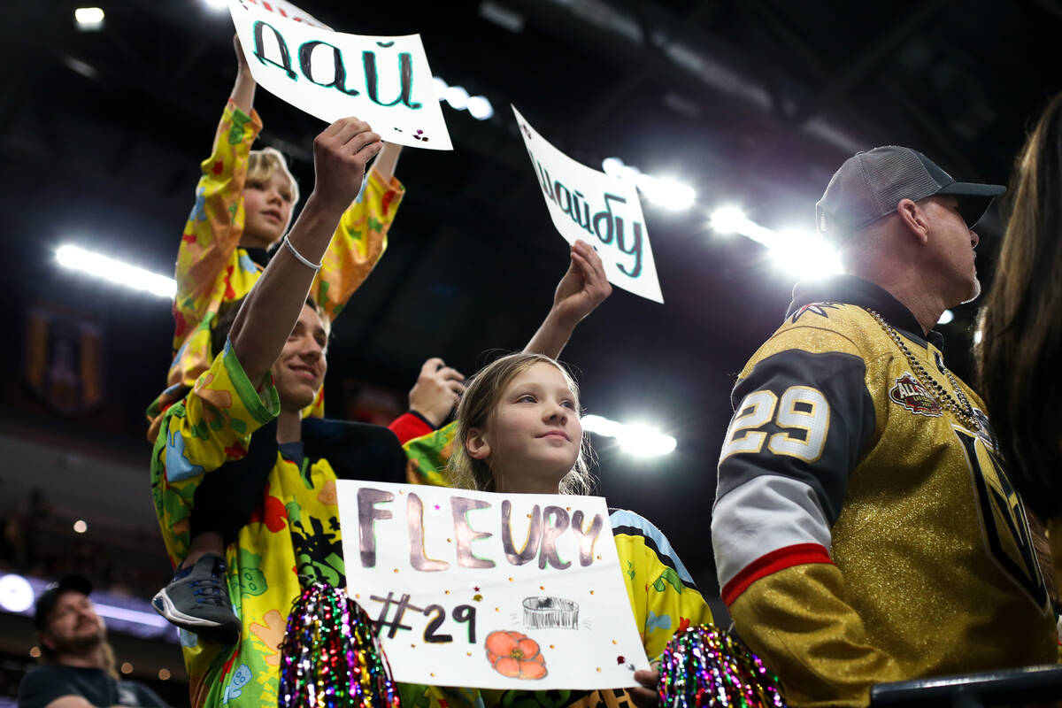 Fans watch former Golden Knight, Wild goaltender Marc-Andre Fleury, during warmups before an NH ...