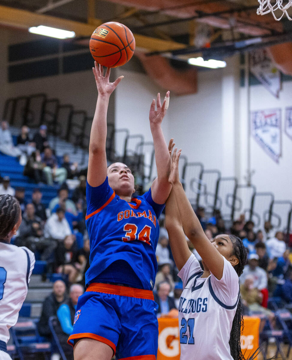 Bishop Gorman guard Savannah Searcy (34) gets off a shot over Centennial guard Aly Brown (21) d ...