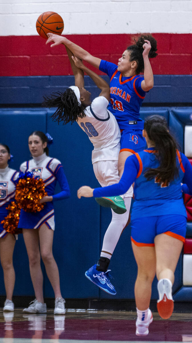 Centennial guard Sanai Branch (10) has a shot blocked by Bishop Gorman guard Aaliah Spaight (10 ...