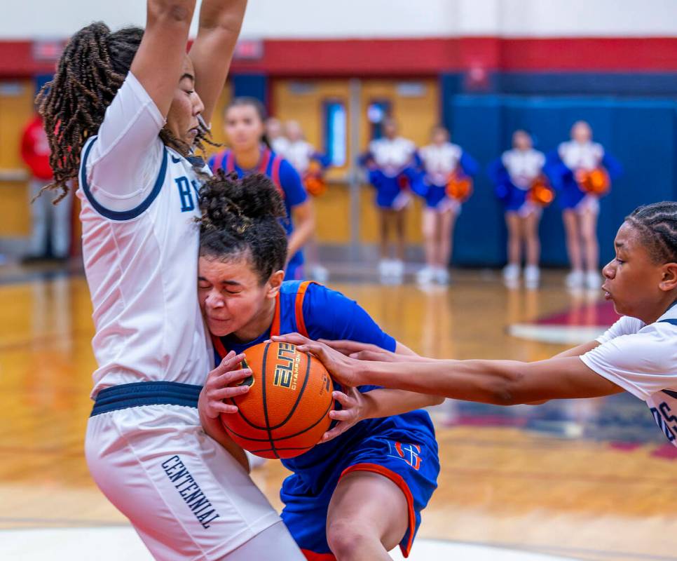 Bishop Gorman guard Aaliah Spaight (10) crashes into Centennial forward Ayla Williams (12) whil ...