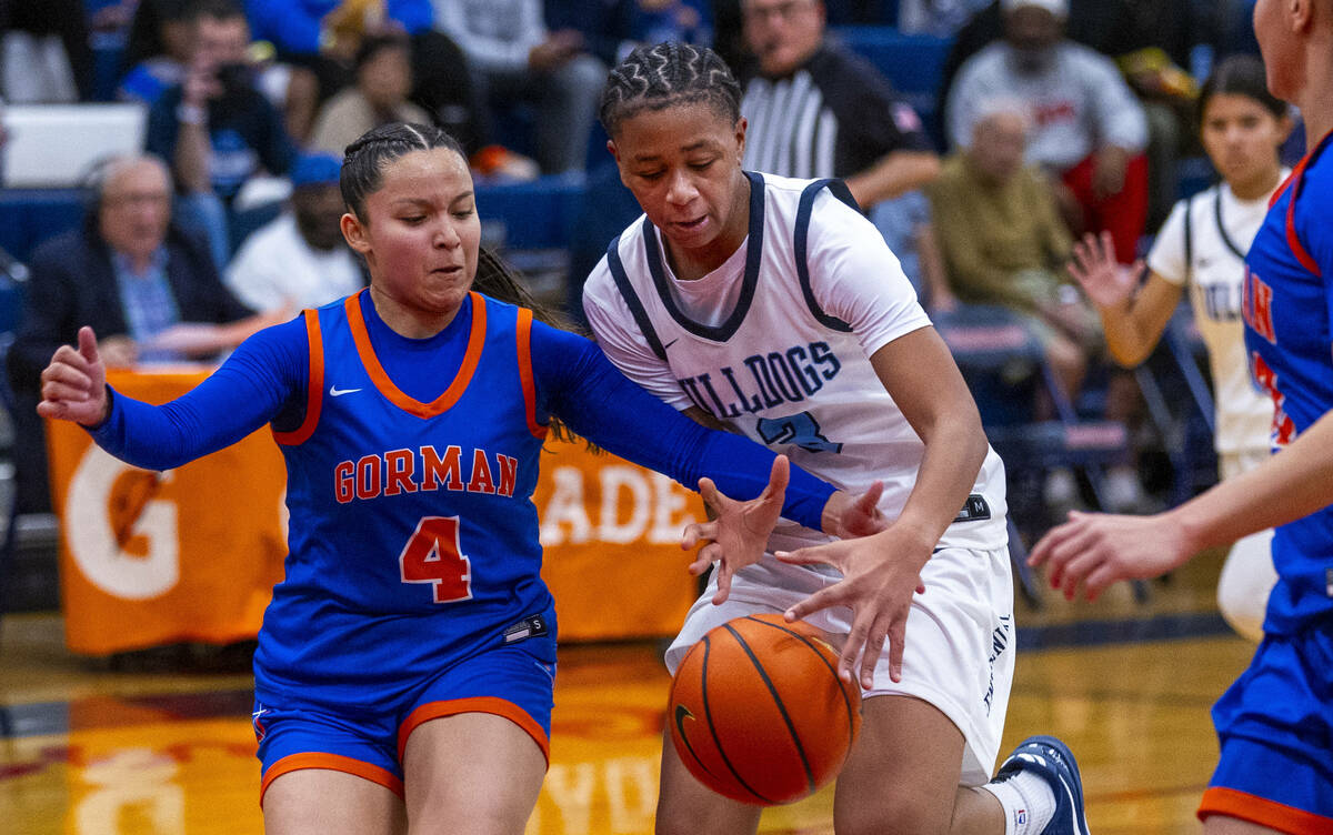 Bishop Gorman guard Anna Barragan (4) works to steal the ball from Centennial guard D'Arrah Mit ...