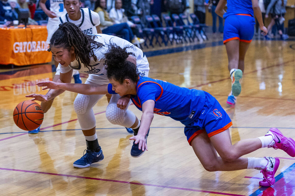 Centennial's forward Ayla Williams (12) keeps possession as Bishop Gorman's guard Aaliah Spaigh ...