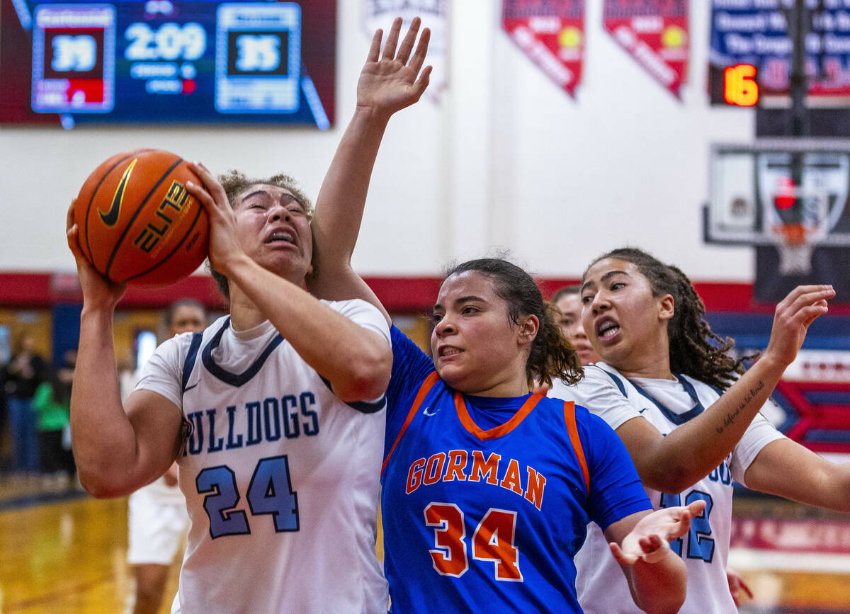 Centennial forward Nation Williams (24) takes an elbow under the basket by Bishop Gorman guard ...