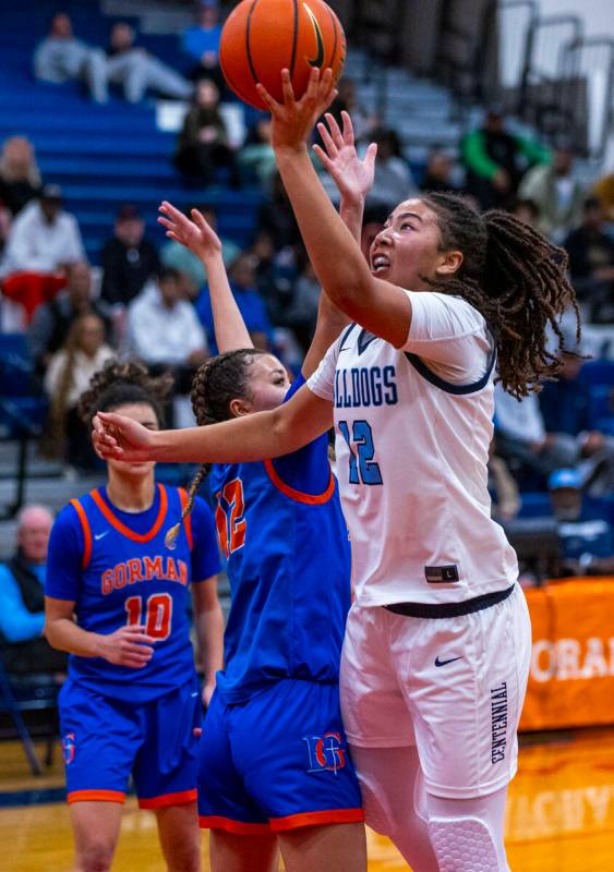 Centennial's forward Ayla Williams (12) scores against Bishop Gorman guard Addysen Carr (12) be ...