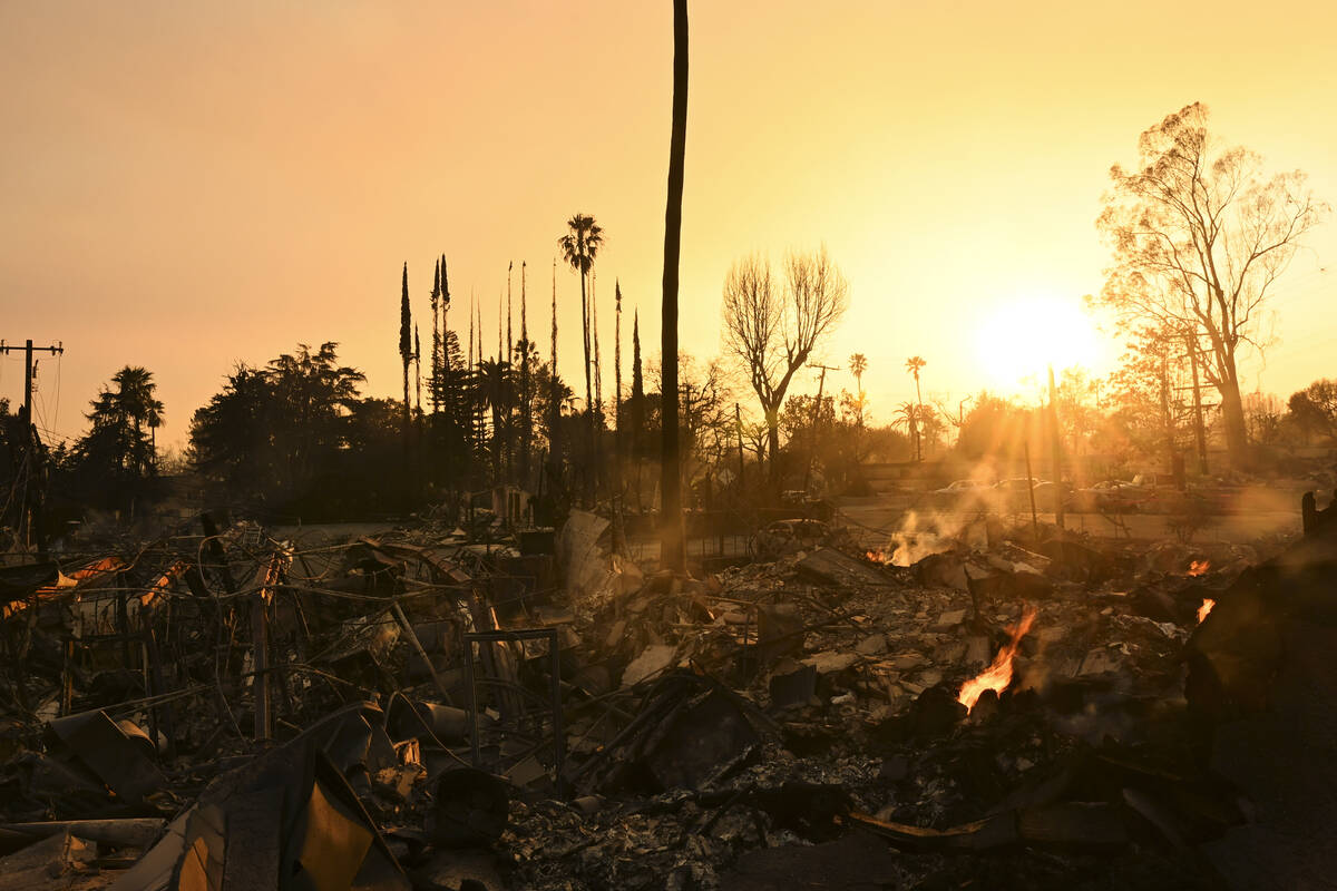 The sun sets over damage from the Eaton Fire, Thursday, Jan. 9, 2025, in Altadena, Calif. (AP P ...