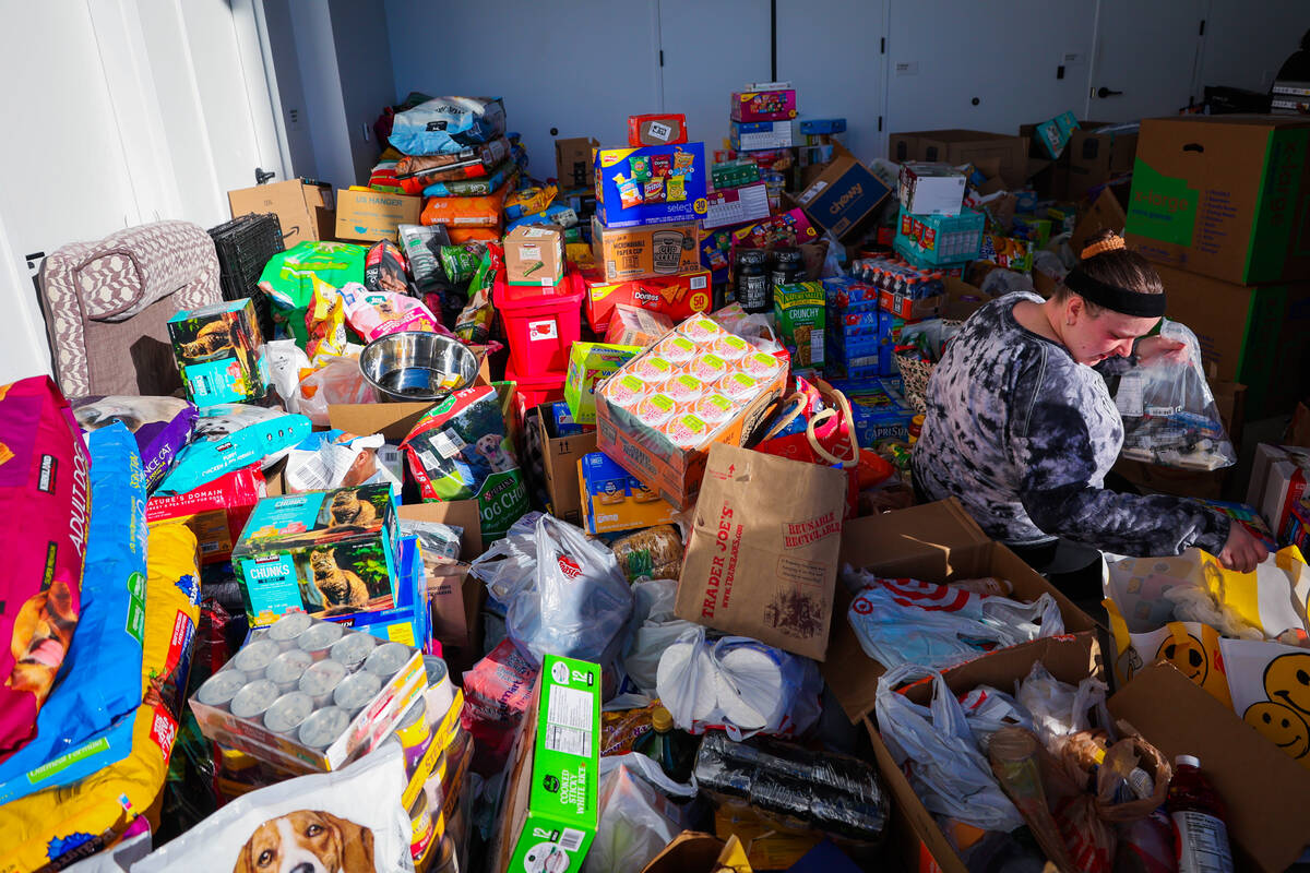 Las Vegas Aces staff sort through donations to send to victims of the Los Angeles wildfires in ...