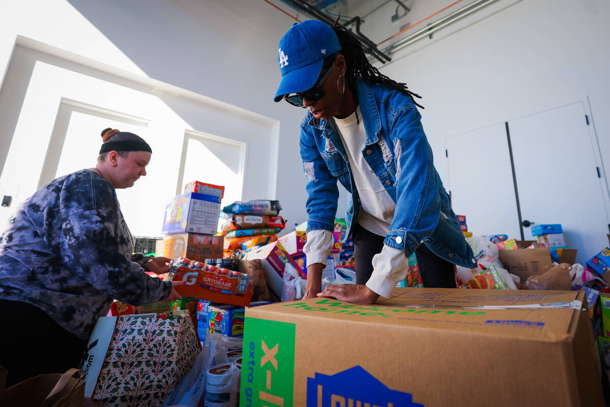 Las Vegas Aces staff sort through donations to send to victims of the Los Angeles wildfires in ...