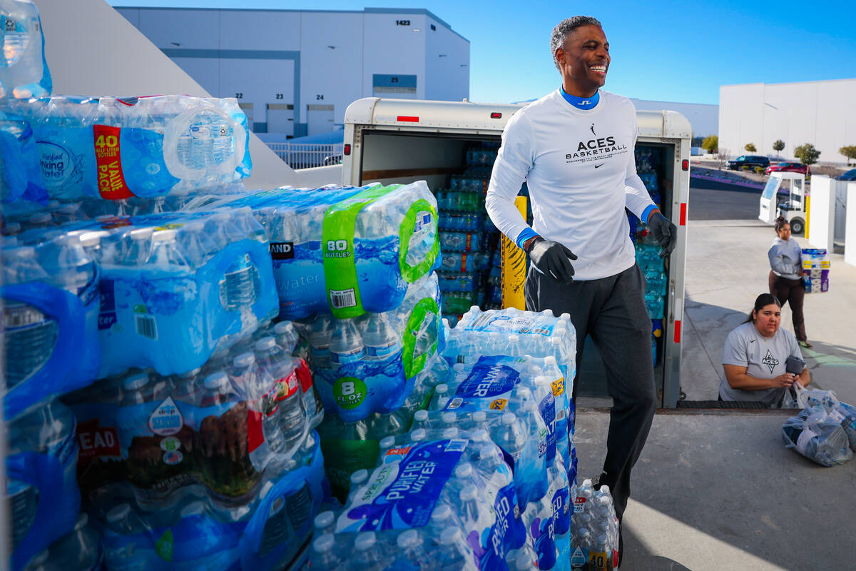 Larry Lewis, Aces assistant coach, helps sort donations with Aces staff to send to victims of t ...