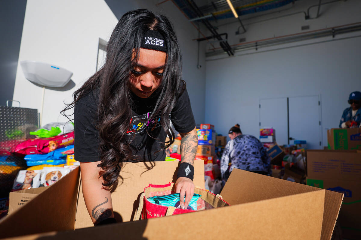 Las Vegas Aces staff sort through donations to send to victims of the Los Angeles wildfires in ...