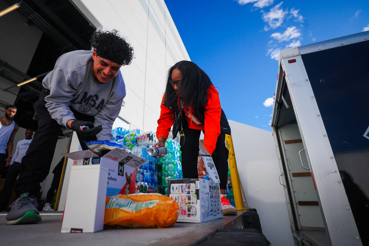 Las Vegas Aces staff sort through donations to send to victims of the Los Angeles wildfires in ...