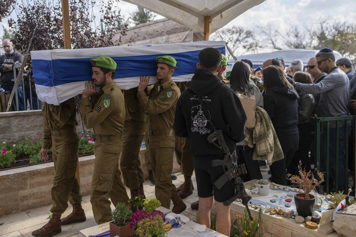 Israeli soldiers and relatives carry the flag-draped casket of Sergeant Yahav Maayan, who was k ...