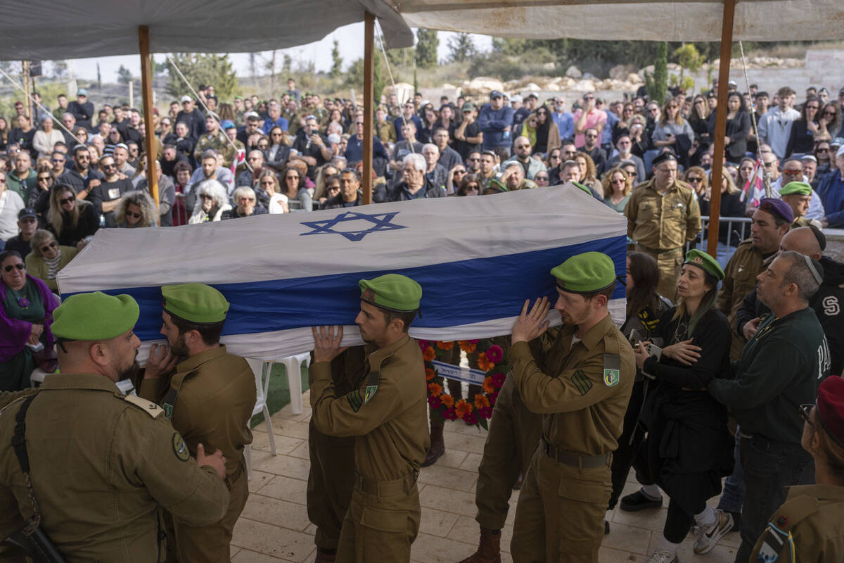 Israeli soldiers and relatives carry the flag-draped casket of Sergeant Yahav Maayan, who was k ...