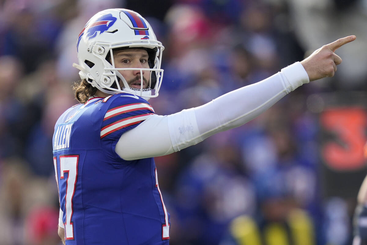 Buffalo Bills quarterback Josh Allen (17) motions for a first down during the first quarter of ...