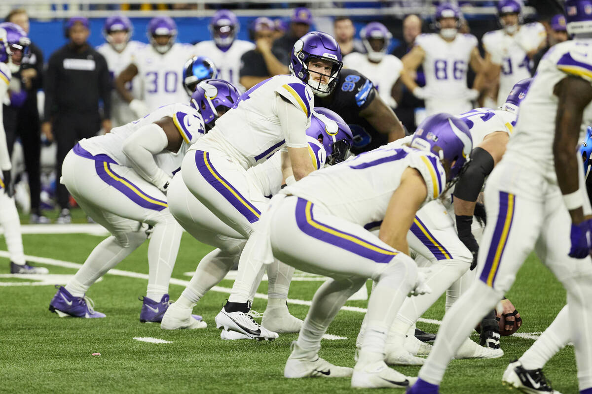 Minnesota Vikings quarterback Sam Darnold (14) gets set to run a play against the Detroit Lions ...