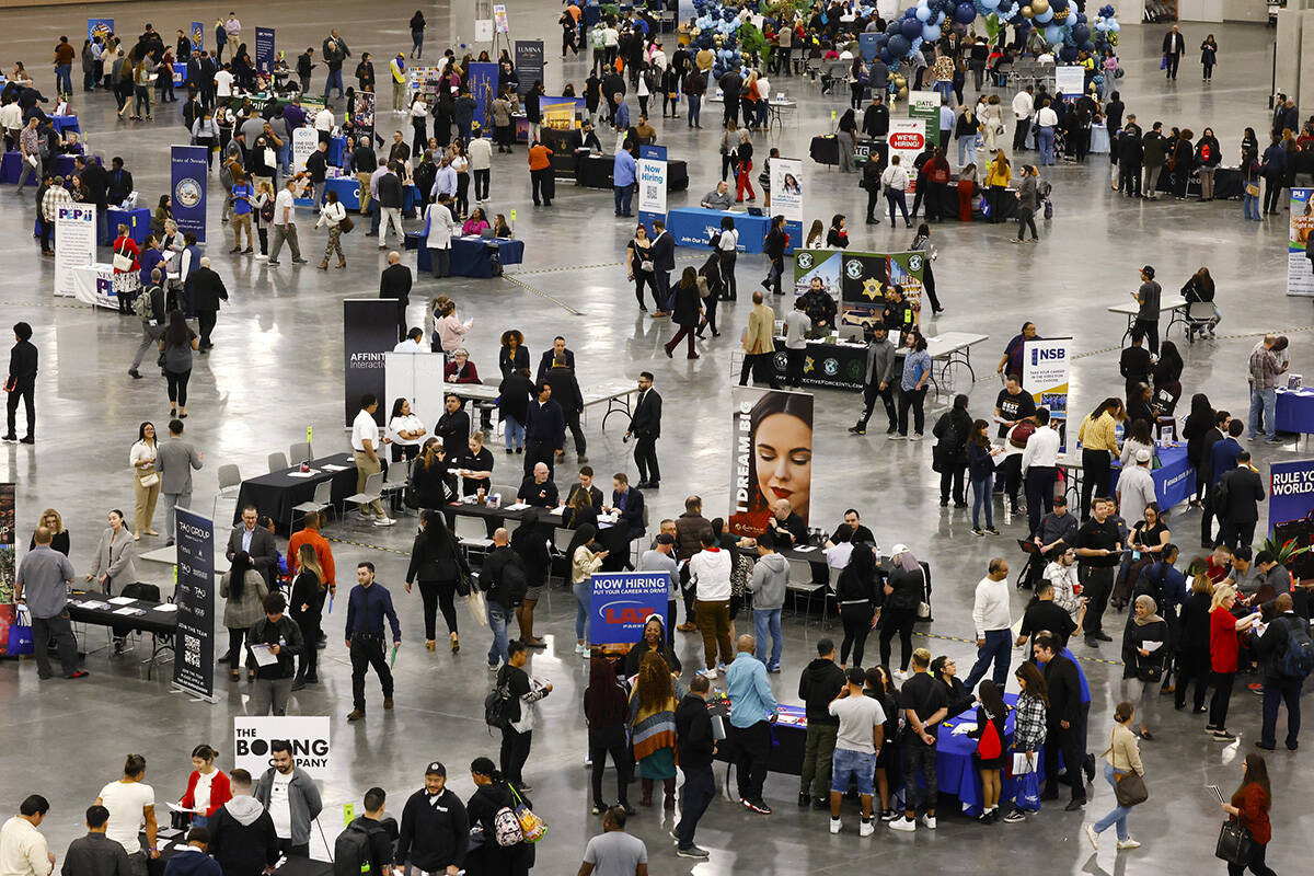 Job seekers visit booths during the annual Spring Job Fair at the Las Vegas Convention Center, ...