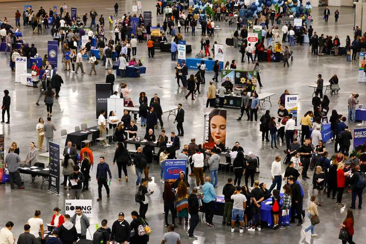 Job seekers visit booths during the annual Spring Job Fair at the Las Vegas Convention Center, ...