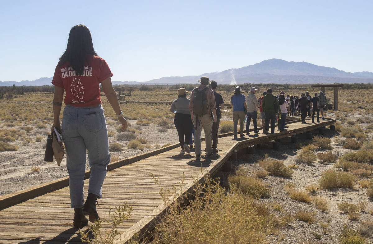 Sarah Arveson, of Oakland, Cali., left, walks on a boardwalk toward the Crystal Spring during t ...