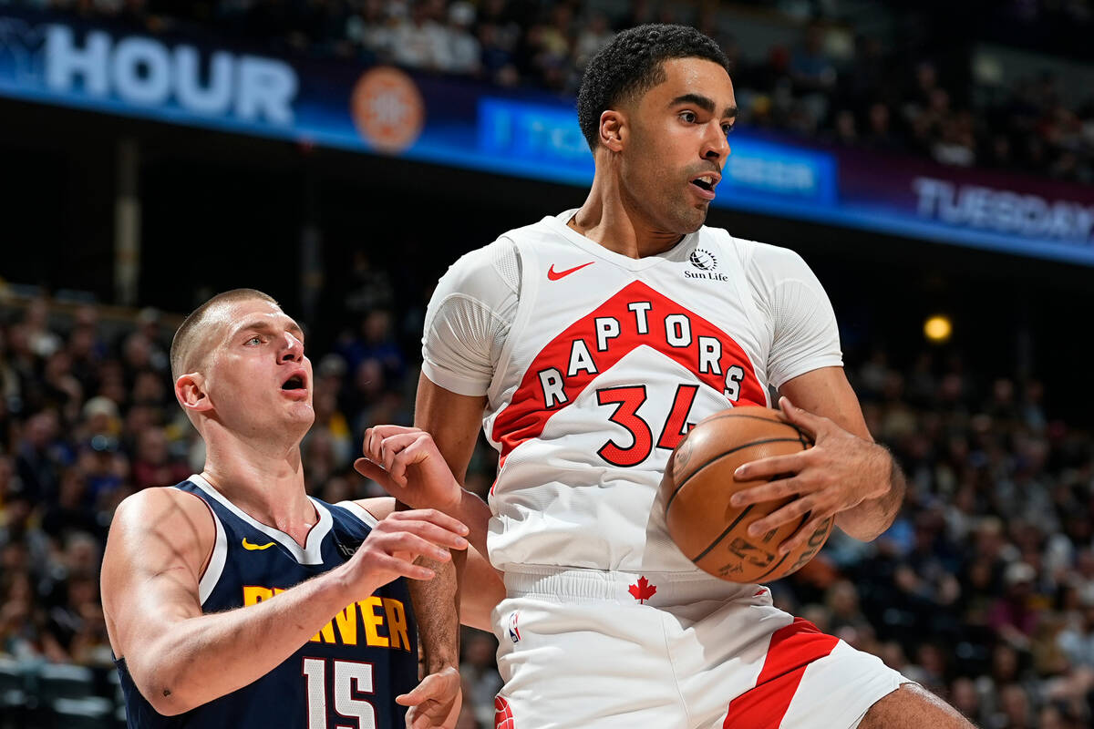 FILE - Toronto Raptors center Jontay Porter, right, pulls in a rebound as Denver Nuggets center ...