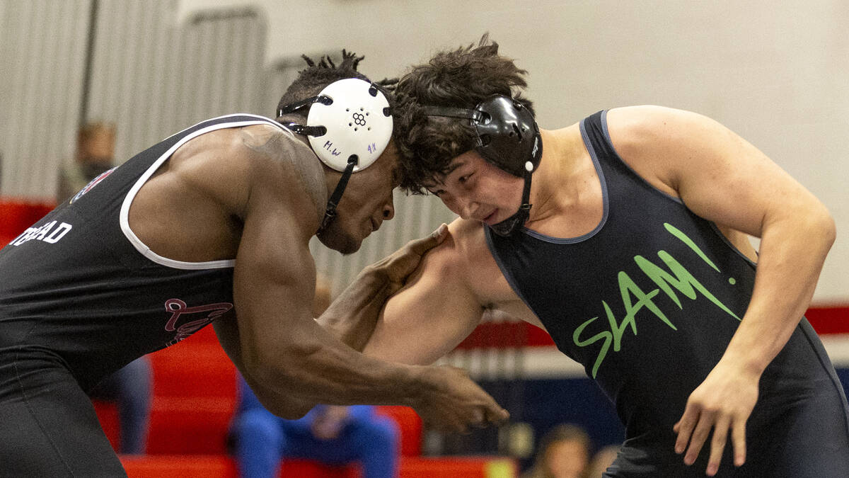 Liberty’s Melvin Whitehead, left, competes against SLAM Academy’s Satoshi Davis, ...