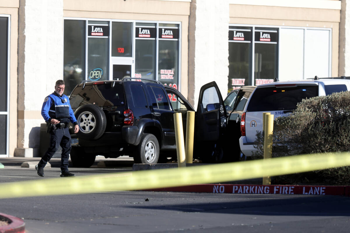 Henderson Police investigate the scene of an officer involved shooting that injured an officer ...