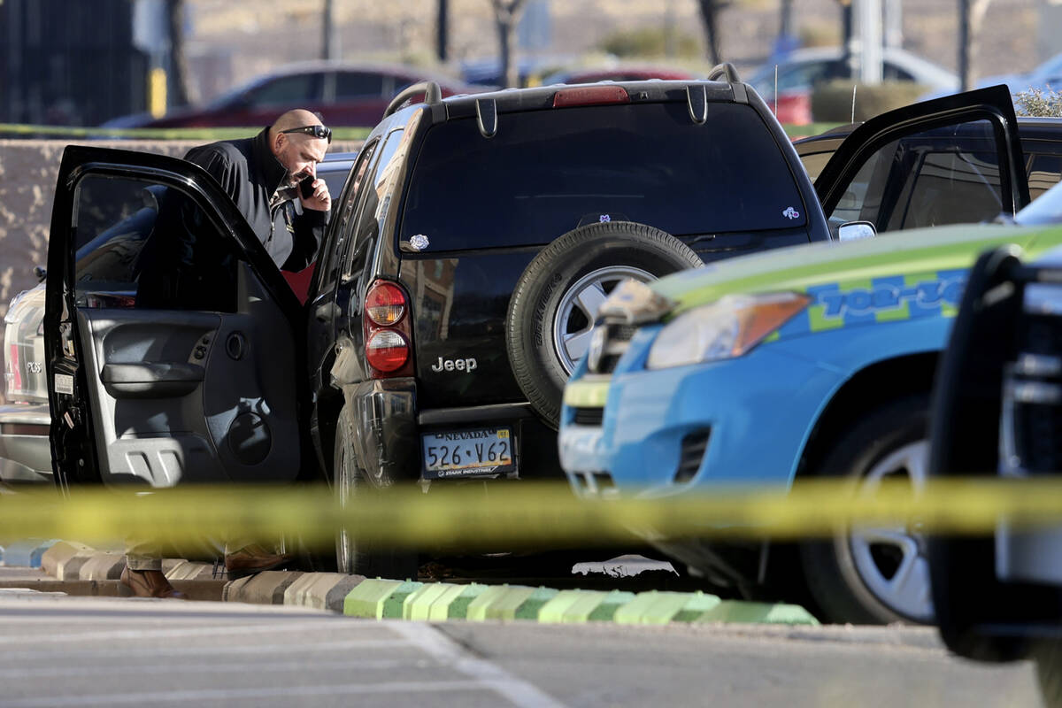 Henderson Police investigate the scene of an officer involved shooting that injured an officer ...