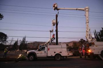 FILE - Southern California Edison workers service a utility pole in the aftermath of the Eaton ...