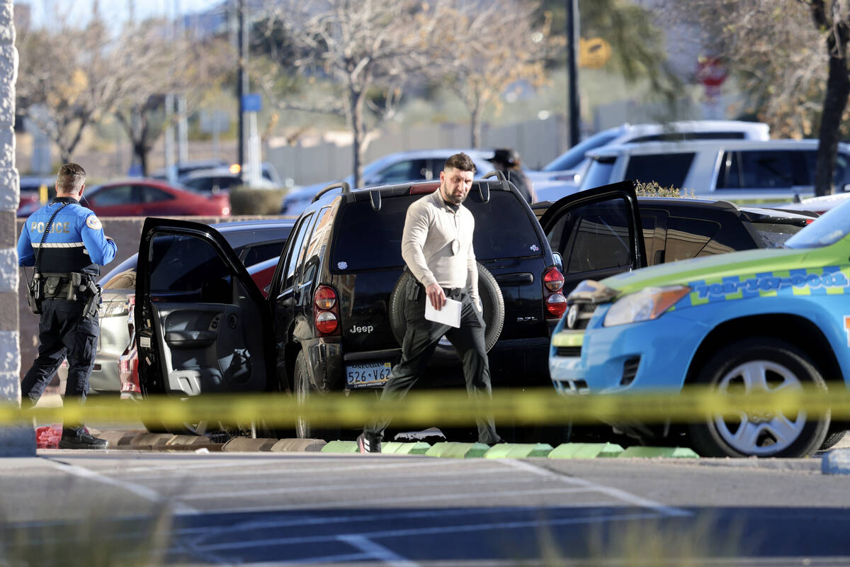 Henderson Police investigate the scene of an officer involved shooting that injured an officer ...