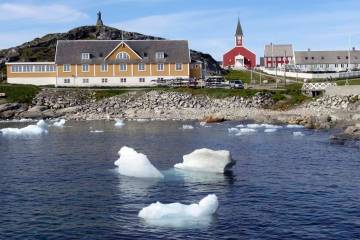 Small pieces of ice float in the water off the shore in Nuuk, Greenland. (AP Photo/Keith Virgo)