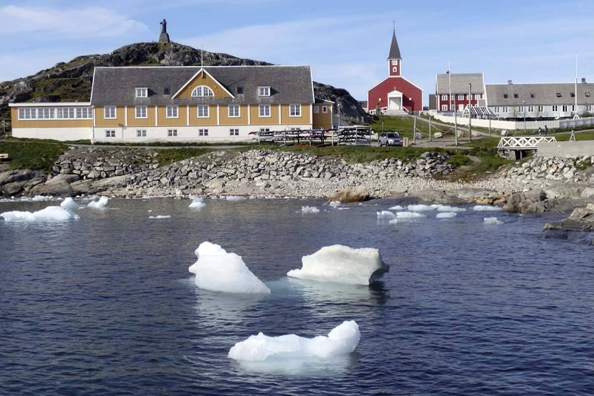 Small pieces of ice float in the water off the shore in Nuuk, Greenland. (AP Photo/Keith Virgo)