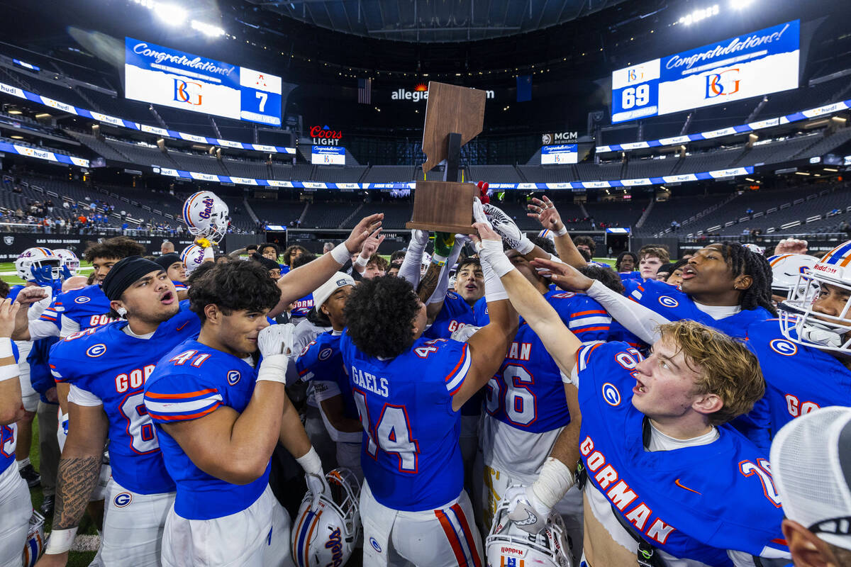 Bishop Gorman hoist their trophy after their 69-7 win over Arbor View for another Class 5A Divi ...