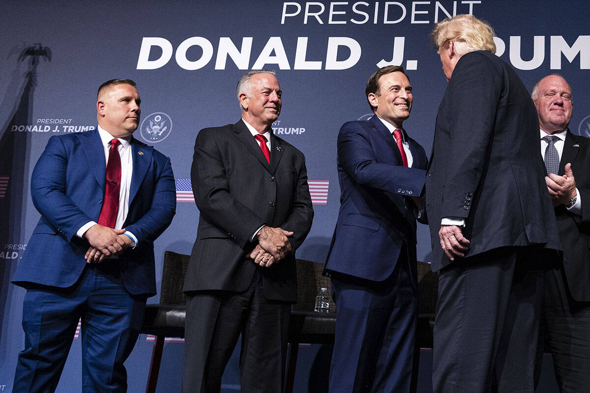 FILE — Former President Donald Trump, right, shakes hand with former Nevada Attorney General ...