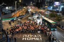 Demonstrators hold torches during a protest calling for the immediate release of the hostages h ...