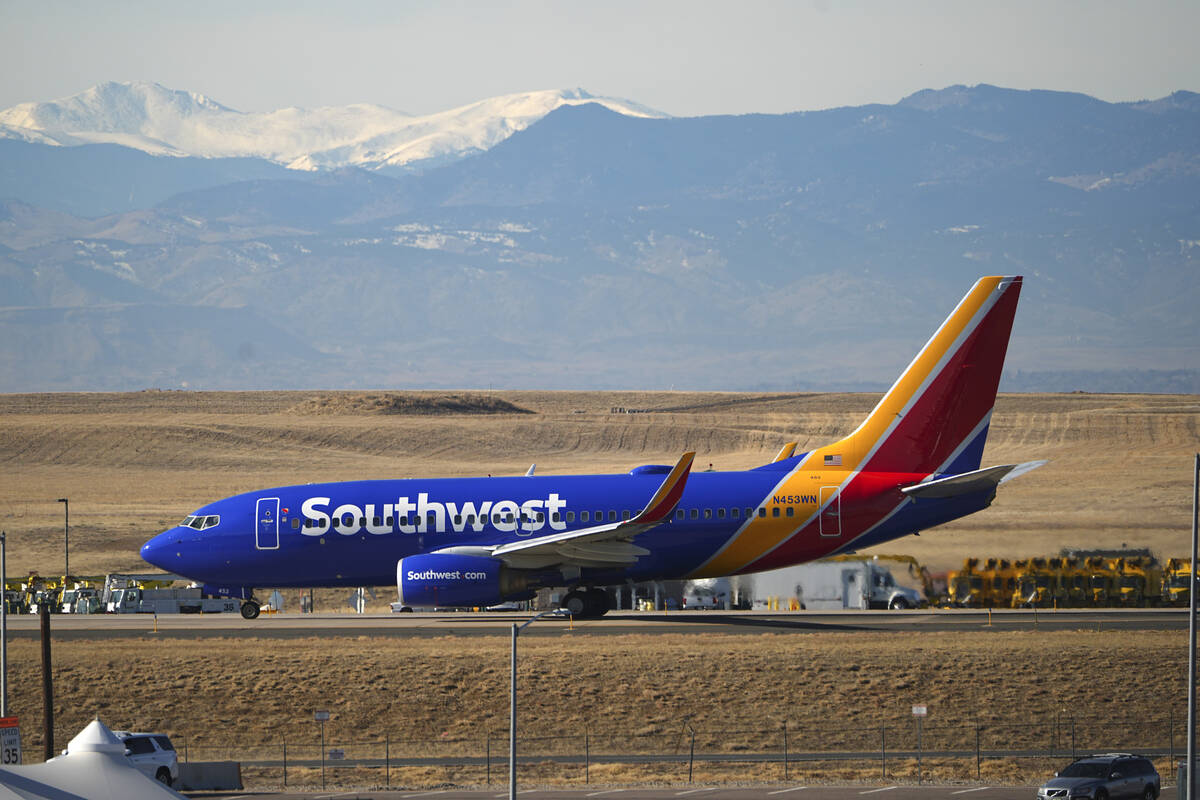 Southwest Airlines jetliner taxis down a runway for take off at Denver International Airport, T ...