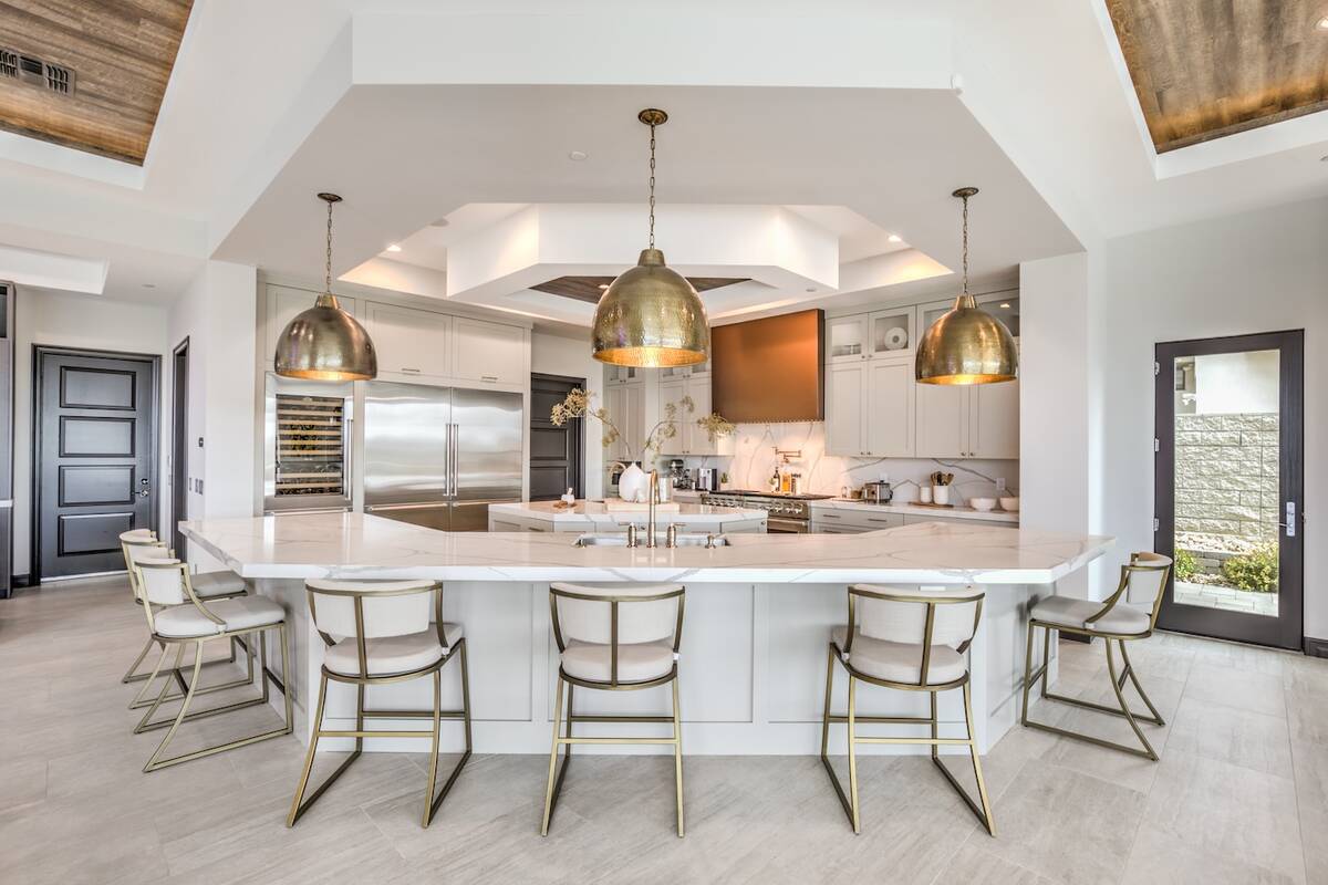 The kitchen features a large island with seating. (Keller Williams Realty Southwest)