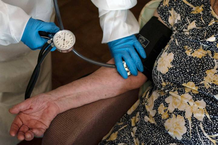 A doctor checks the blood pressure of A 94-year-old woman in Sant Sadurní d'Anoia, Catalonia r ...