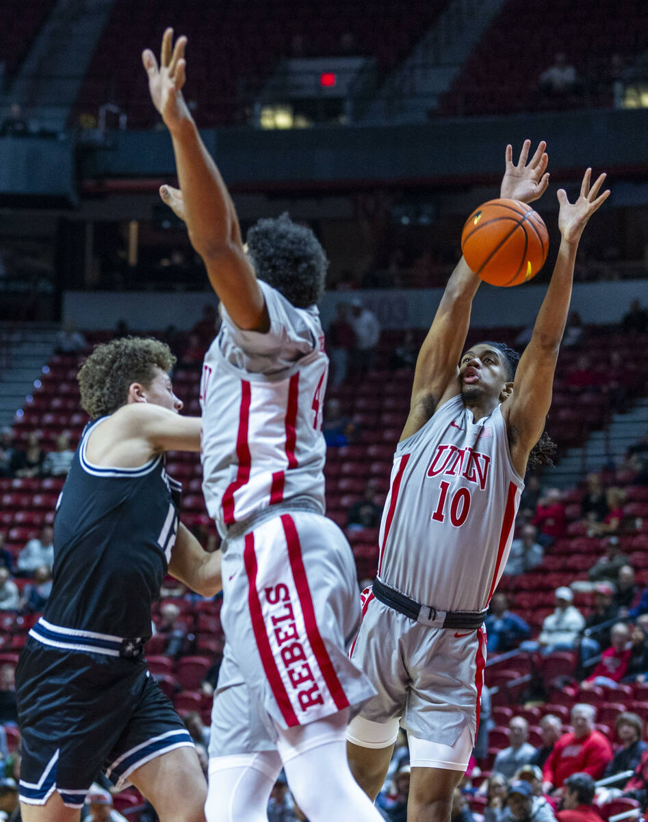 UNLV guard Jaden Henley (10) blocks a pass by Utah State Aggies guard Mason Falslev (12) during ...