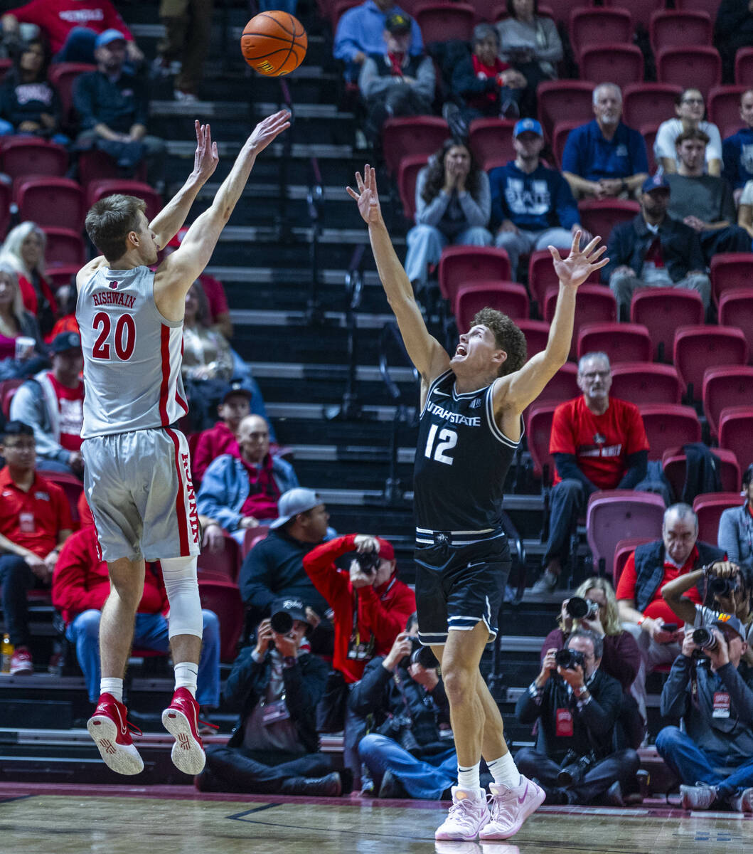 UNLV guard Julian Rishwain (20) shoots over Utah State Aggies guard Mason Falslev (12) during t ...