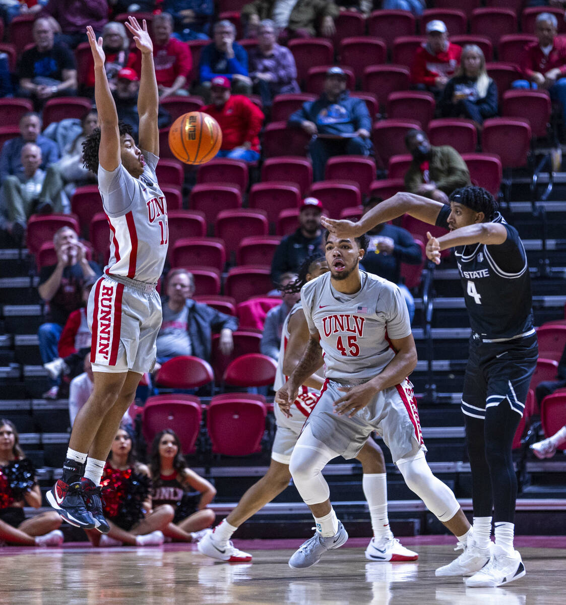 UNLV guard Dedan Thomas Jr. (11) leaps upon for a block attempt as Utah State Aggies guard Ian ...